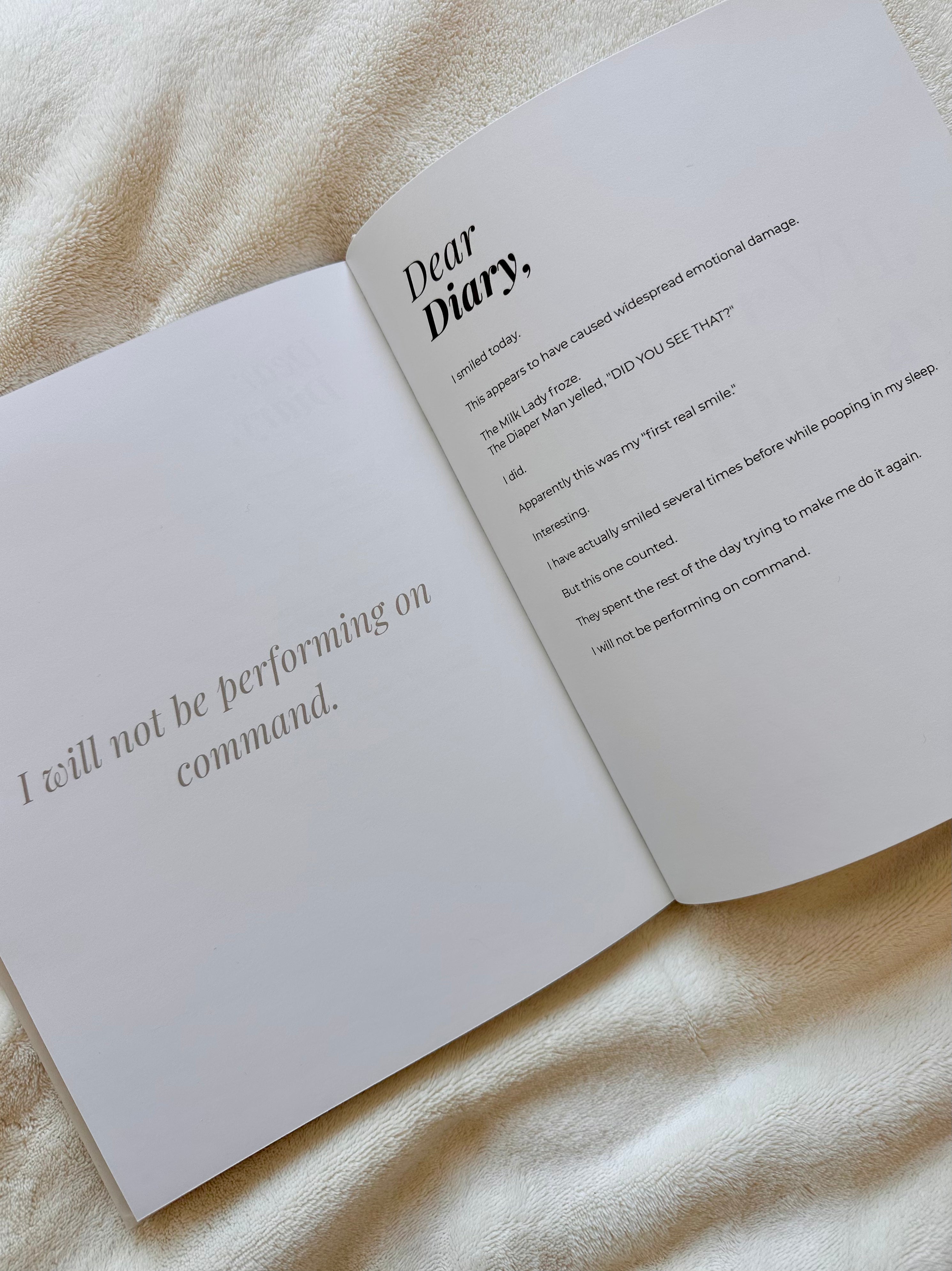 Open Dear Diary book showing a Baby Boss diary entry beside a coffee cup and pen